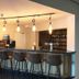 Fletcher Hotel Restaurant De Gelderse Poort bar area in Ooij with high stools and pendant lights