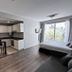 CH Recoleta Suites Buenos Aires suite with kitchenette, dining table, sofa bed, and city-view window