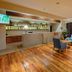 Hotel Somadevi Angkor Boutique and Resort lobby lounge with wooden floors and blue armchairs in Siem Reap
