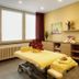Parkhotel Cup Vitalis in Bad Kissingen treatment room with massage table and floral decor
