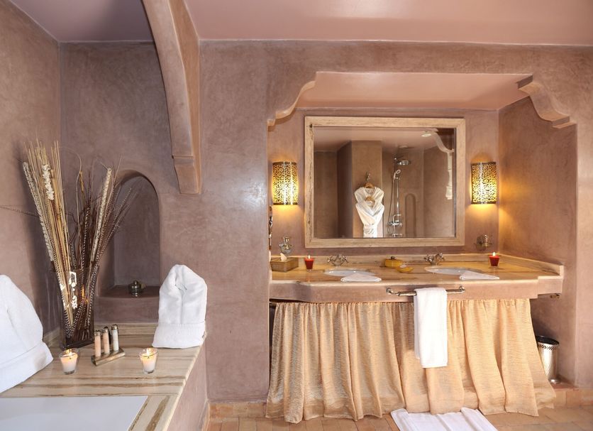 Riad Al Mendili Private Resort & Spa spa bathroom in Marrakech with twin sinks, mirror and candlelight