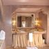 Riad Al Mendili Private Resort & Spa spa bathroom in Marrakech with twin sinks, mirror and candlelight
