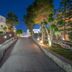Diana Palace Hotel Zakynthos in Argassi, lit pathway lined with trees beside the hotel at night