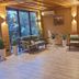 Kausar Hotel in Bishkek lounge with seating, plants, large window and guests sitting inside