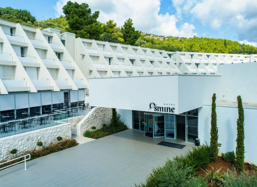 Hotel Osmine in Slano, modern white hillside hotel entrance with sea-view terraces and greenery