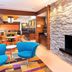 Fairfield Inn & Suites by Marriott Galesburg lobby with blue chairs, stone fireplace and colorful rug