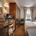 Hotel De La Poste, Cortina d'Ampezzo guest room with twin beds, desk, and window view