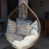 Hope Pousada in Arraial do Cabo: hanging wicker egg chair with striped cushions on a patio