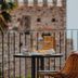 Médousa Suites in Taormina balcony with table, wicker chair and castle view