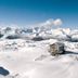Hotel Pinzolo-Dolomiti in Pinzolo overlooks snowy alpine peaks and a snow-covered mountain slope