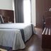 Hotel Portas De Santa Rita guest room in Ermesinde with twin beds, desk, and wardrobe