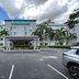 La Quinta Inn & Suites by Wyndham Sawgrass in Sunrise exterior entrance with palm trees and parking lot