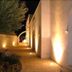 Masseria Magli Resort in Martina Franca with lit stone walkway and arched exterior at night
