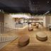 Hotel Villa Fontaine Grand Tokyo-Ariake lobby with wood floors, circular seating, and open reception area in Tokyo