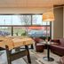 B&B HOTEL Maubeuge-Louvroil lobby with foosball table, seating area, and large street-facing windows