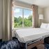 Fairfield Inn & Suites by Marriott Harrisburg Hershey guest room with sofa bed and window view of trees