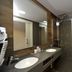 Hotel Vall D'Aneu bathroom with double sink vanity and glass shower in Esterri d'Àneu