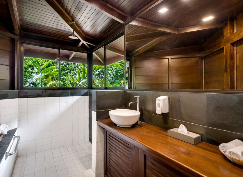 Chachagua Rainforest Hotel & Hot Springs in Chachagua bathroom with open-air shower and wooden vanity