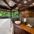 Chachagua Rainforest Hotel & Hot Springs in Chachagua bathroom with open-air shower and wooden vanity