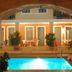 Vecchio Hotel, Rethymno: outdoor pool glowing under an arched terrace with poolside seating