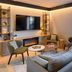 Campanile Nature - Cahors lounge with sofa, armchairs, fireplace and garden-view glass door in Cahors