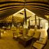 The Deer Park Hotel in Giritale: open-air lounge with seating beneath a curved wooden roof