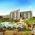 Disney's Riviera Resort in Lake Buena Vista with a large pool, loungers, palm trees, and resort buildings