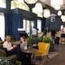 Aparthotel Adagio Lyon Patio Confluence lounge with seating area, bar, and large hanging lights in Lyon