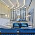 Grand Josun Busan lobby with blue seating, marble front desk and tall glass windows