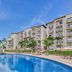 Fiesta Americana Cancun Villas in Cancún with a curved pool, palm trees, and beachfront resort buildings
