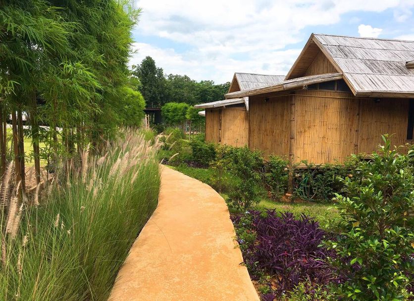 Baansuanpai Noppakao in Ban Mo Takhian, garden path beside bamboo bungalows and lush landscaping