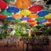 Hotel Posada De Roger in Puerto Vallarta patio with colorful hanging umbrellas and a fountain