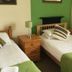 The Kings Arms London triple room with three single beds and green accent wall