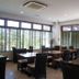 Hotel Patina Ishigakijima in Ishigaki dining area with tables, wicker chairs, and large windows