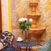 Maya Campeche Hotel in Campeche: courtyard fountain, bistro table, chairs, and potted plants