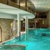 Indoor pool at Hotel & Spa Wasserschloss Westerburg in Huy with stone walls and arched windows