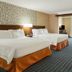 Fairfield Inn & Suites by Marriott Akron Fairlawn guest room with two double beds and sitting area