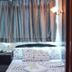 Woodstock Hostel Hong Kong guest room with two single beds, bedside table, and curtained window