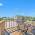Carousel Suites -Redington Shores rooftop deck with table, chairs and ocean view in Redington Shores