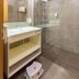 Thermenhotel Kurz in Lutzmannsburg bathroom with glass shower, wall mirror and floating sink