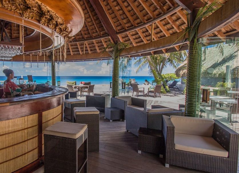 Maitai Rangiroa in Avatoru with thatched beachfront bar seating and ocean views