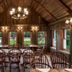 Rokeby Manor in Invergarry: rustic dining room with wooden tables, chairs, chandelier and large windows