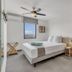 Grand Windsock Bonaire in Kralendijk: bright guest room with bed, wardrobe, ceiling fan and window view