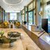 Kaya Palazzo Golf Resort Belek lobby lounge with seating, floor-to-ceiling windows, and modern lighting