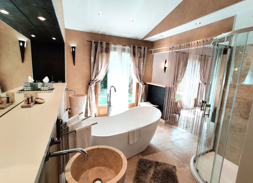 Maison Prestige Roberto Geissini in Grimaud bathroom with freestanding tub, walk-in shower and vanity