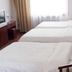 Jia Hao hotel in Beijing guest room with two neatly made beds and a window with curtains