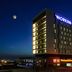 Workinn Hotel in Gebze at night with illuminated facade and moonlit sky