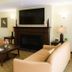 Ambassador Inn and Suites Tuscaloosa lounge with sofas, fireplace and wall-mounted TV