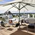 Hotel mein inselglück terrace with umbrella seating and lake view in Reichenau