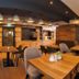 Hotel Amberger Hof in Bad Kotzting lobby-style restaurant with wooden tables, bar shelves, and pendant lights